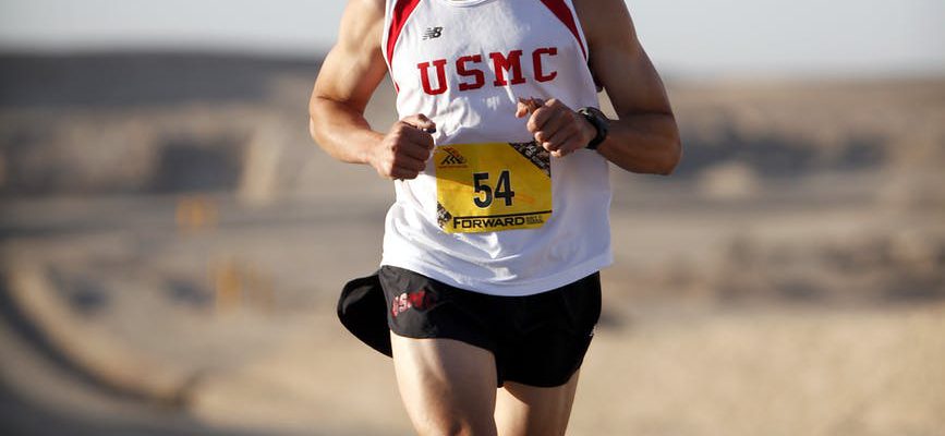 man in white jersey while running