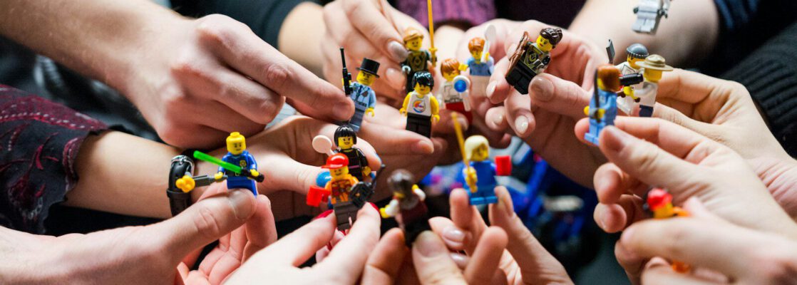 people holding miniature figures