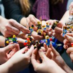 people holding miniature figures