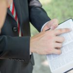 a close up of a person writing on a book