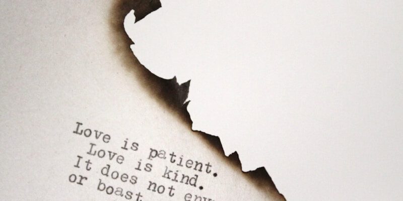Love is patient Love is kind printed on burned paper