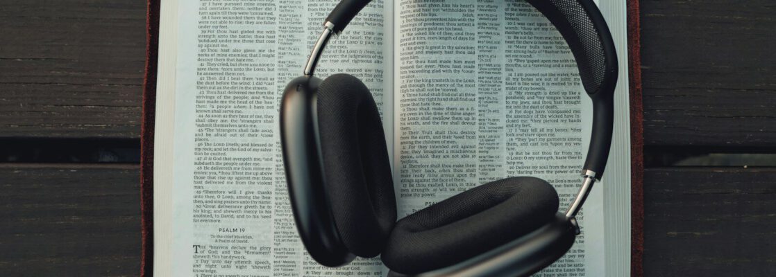 black wireless headphones on white book page