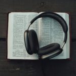 black wireless headphones on white book page