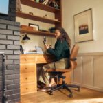Woman working at a desk in a cozy home office.